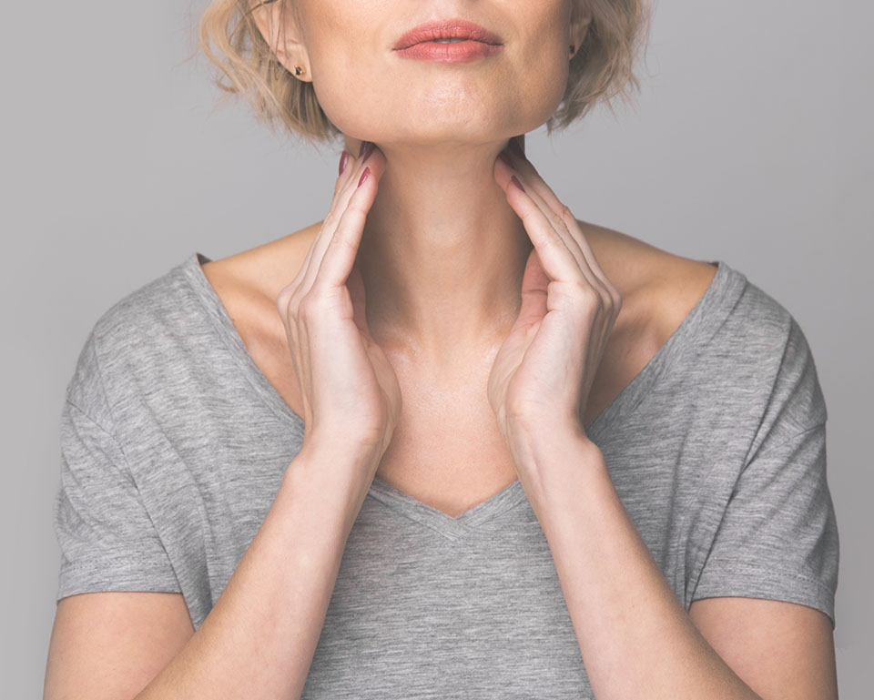 woman checking her thyroid gland