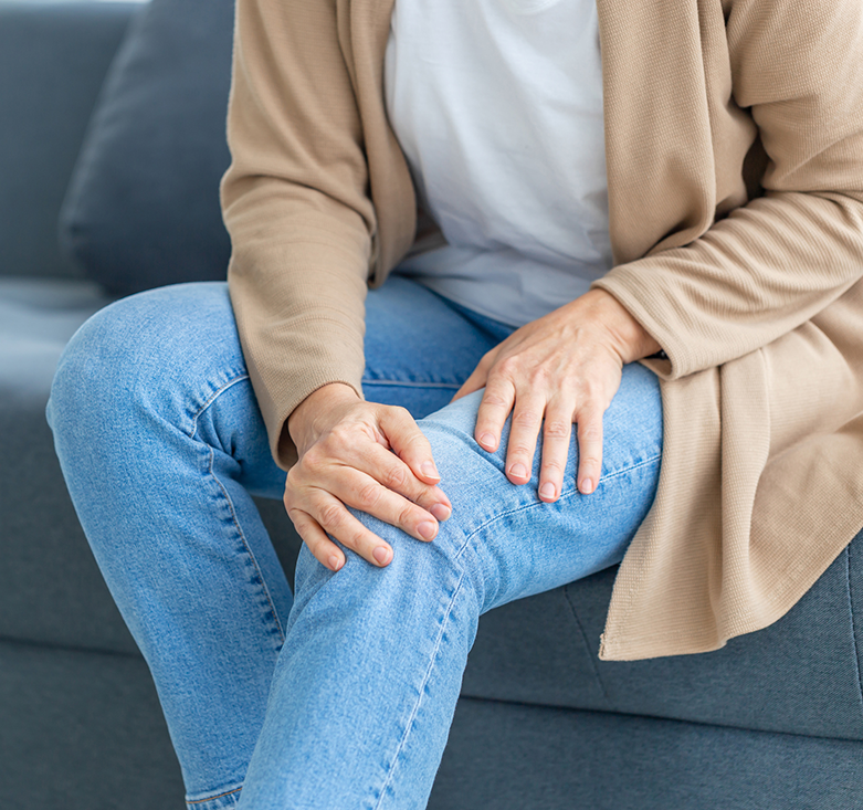 woman holding her knee due to osteoarthritis