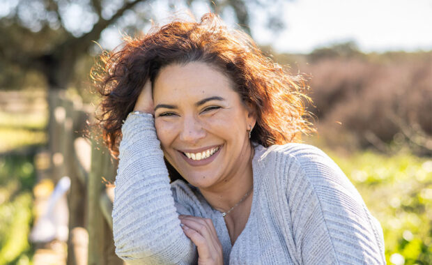Woman Smiling In A Field