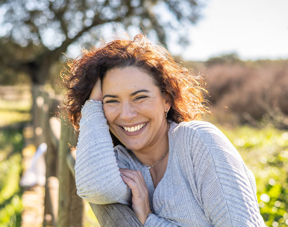 Woman Smiling In A Field